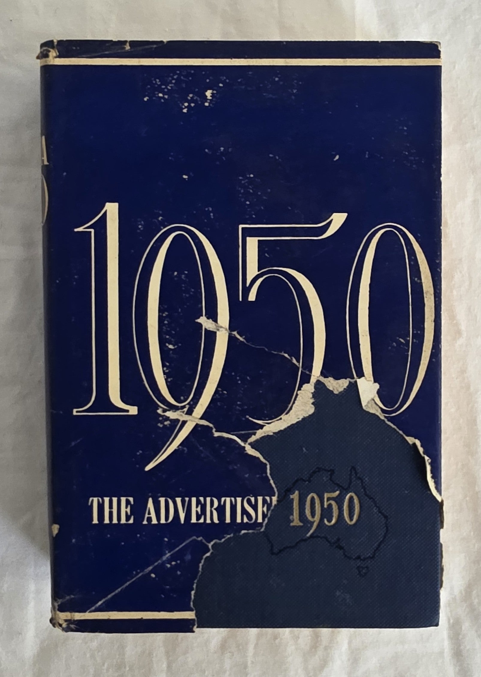 Vintage book cover from 1950 with 'The Advertiser' branding on a textured white background