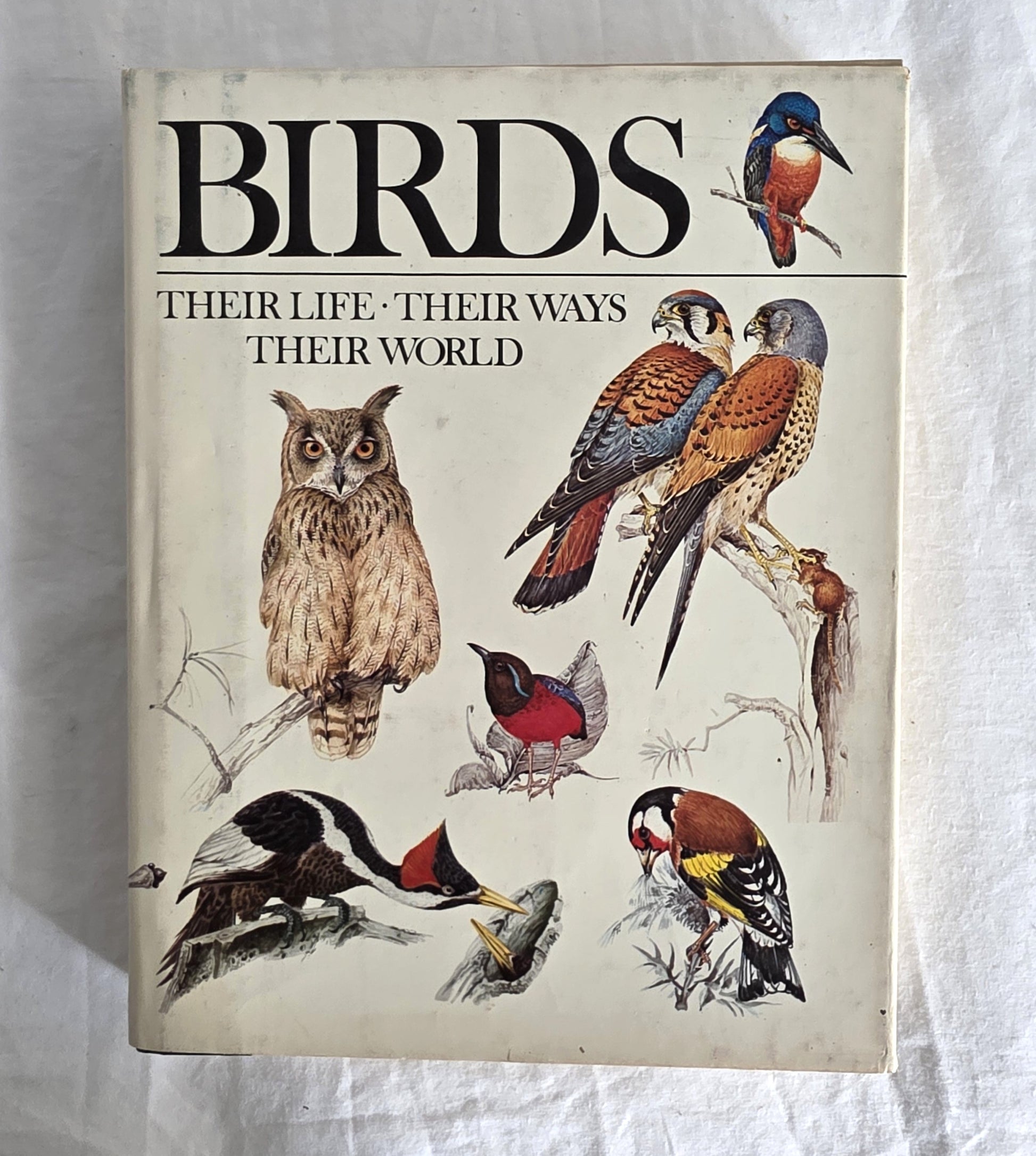 Book cover of 'Birds: Their Life, Their Ways, Their World' with illustrations of various birds on a light background.