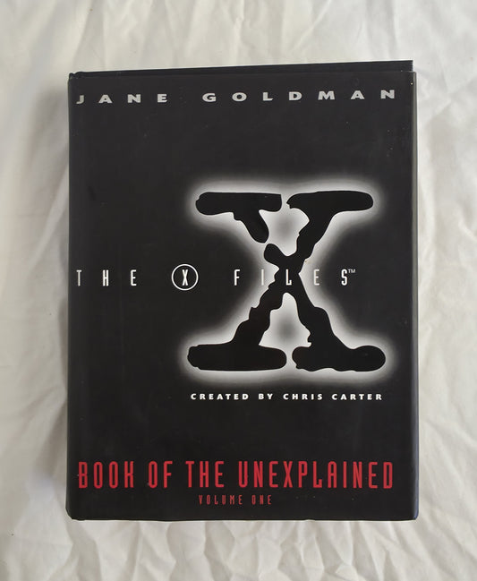 Book titled 'The X-Files Book of the Unexplained' by Jane Goldman on a white background