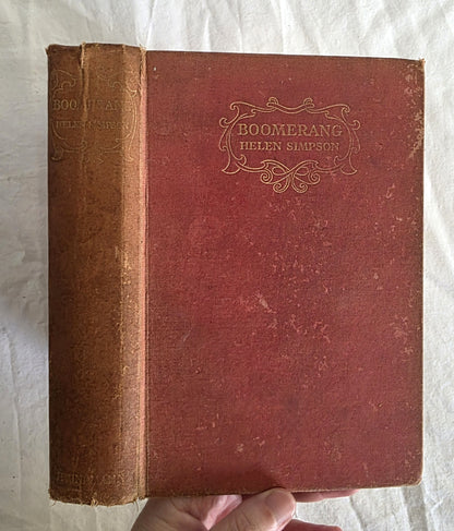 Red book titled 'Boomerang' by Helen Simpson held against a textured white background