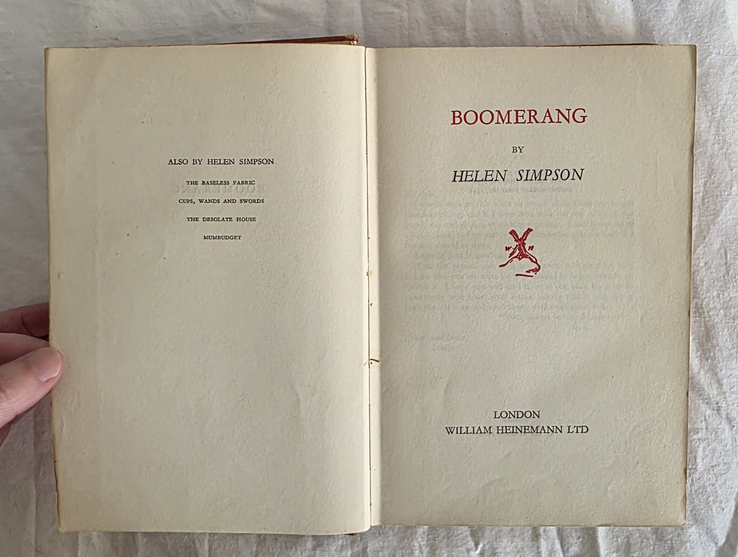 Open book titled 'Boomerang' by Helen Simpson on a textured surface