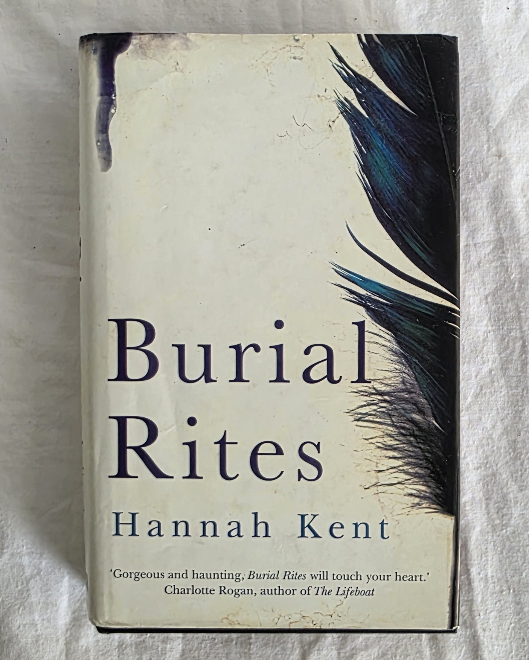 Book titled 'Burial Rites' by Hannah Kent with feather design on cover