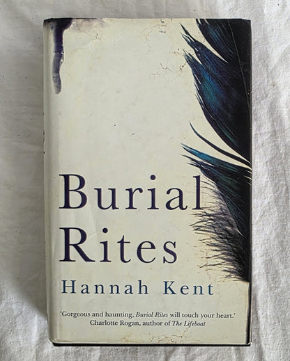 Book titled 'Burial Rites' by Hannah Kent with feather design on cover