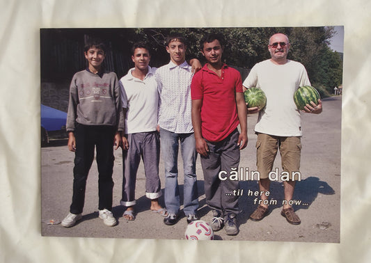 Five men standing together outdoors, with one holding a watermelon, on a textured white background.