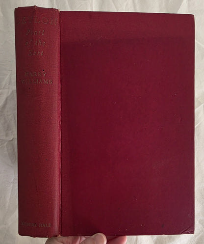 Red book held by a hand on a white background