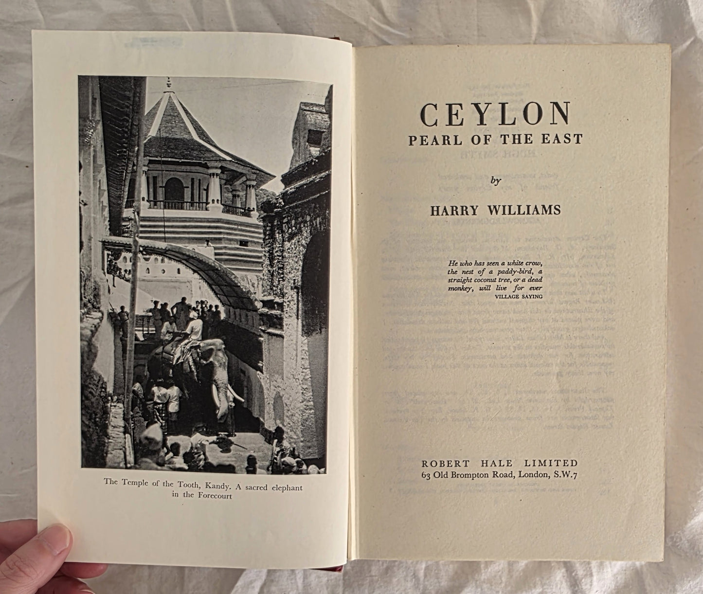 Open book titled 'Ceylon Pearl of the East' by Harry Williams, with a black and white photograph on the left page.