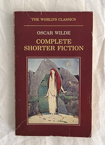 Book cover of 'The World's Classics' by Oscar Wilde featuring a woman with red hair in a natural setting.