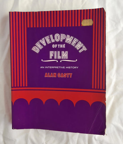 Book titled 'Development of the Film: An Interpretive History' by Alan Casty on a white background