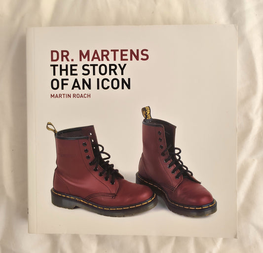 Book titled 'Dr. Martens: The Story of an Icon' with a pair of red boots on a beige background