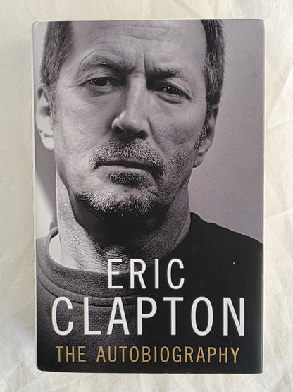 Book cover of 'The Autobiography' by Eric Clapton with a black and white portrait on a textured beige background.