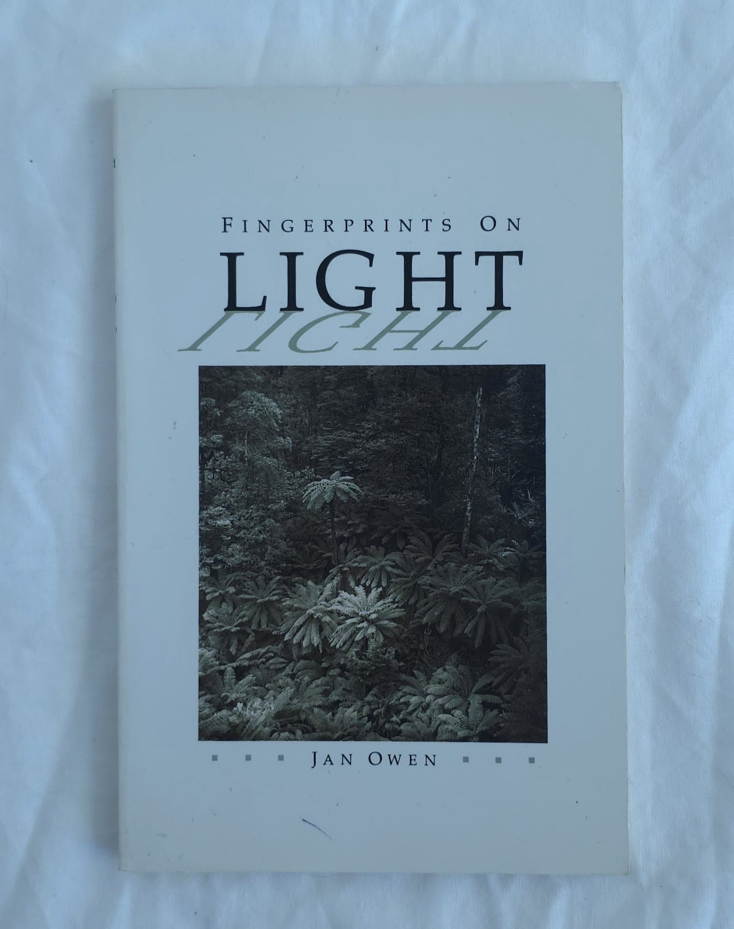 Book titled 'Fingerprints on Light' by Jan Owen on a white background