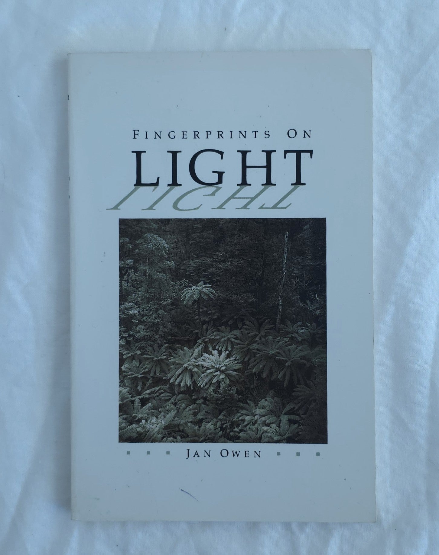 Book titled 'Fingerprints on Light' by Jan Owen on a white background