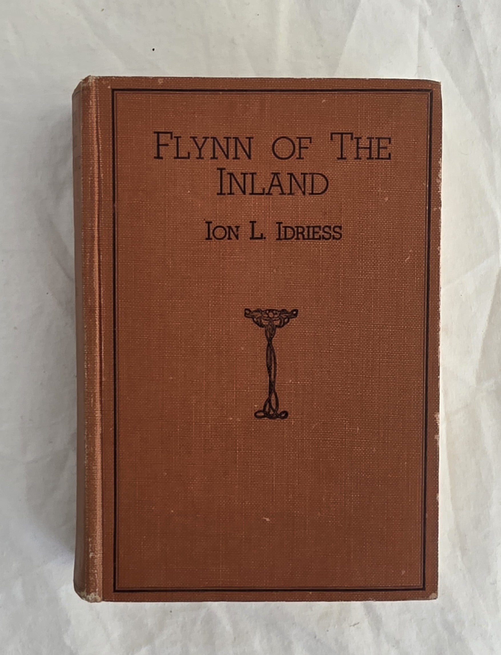 Book titled 'Flynn of the Inland' by Ion L. Idriess on a textured white background