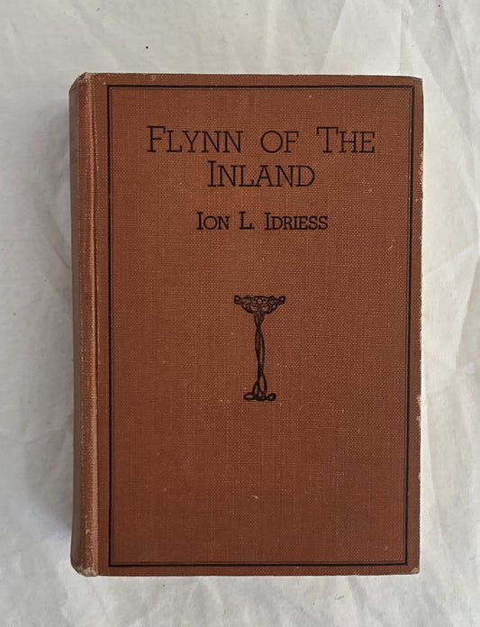 Book titled 'Flynn of the Inland' by Ion L. Idriess on a textured white background
