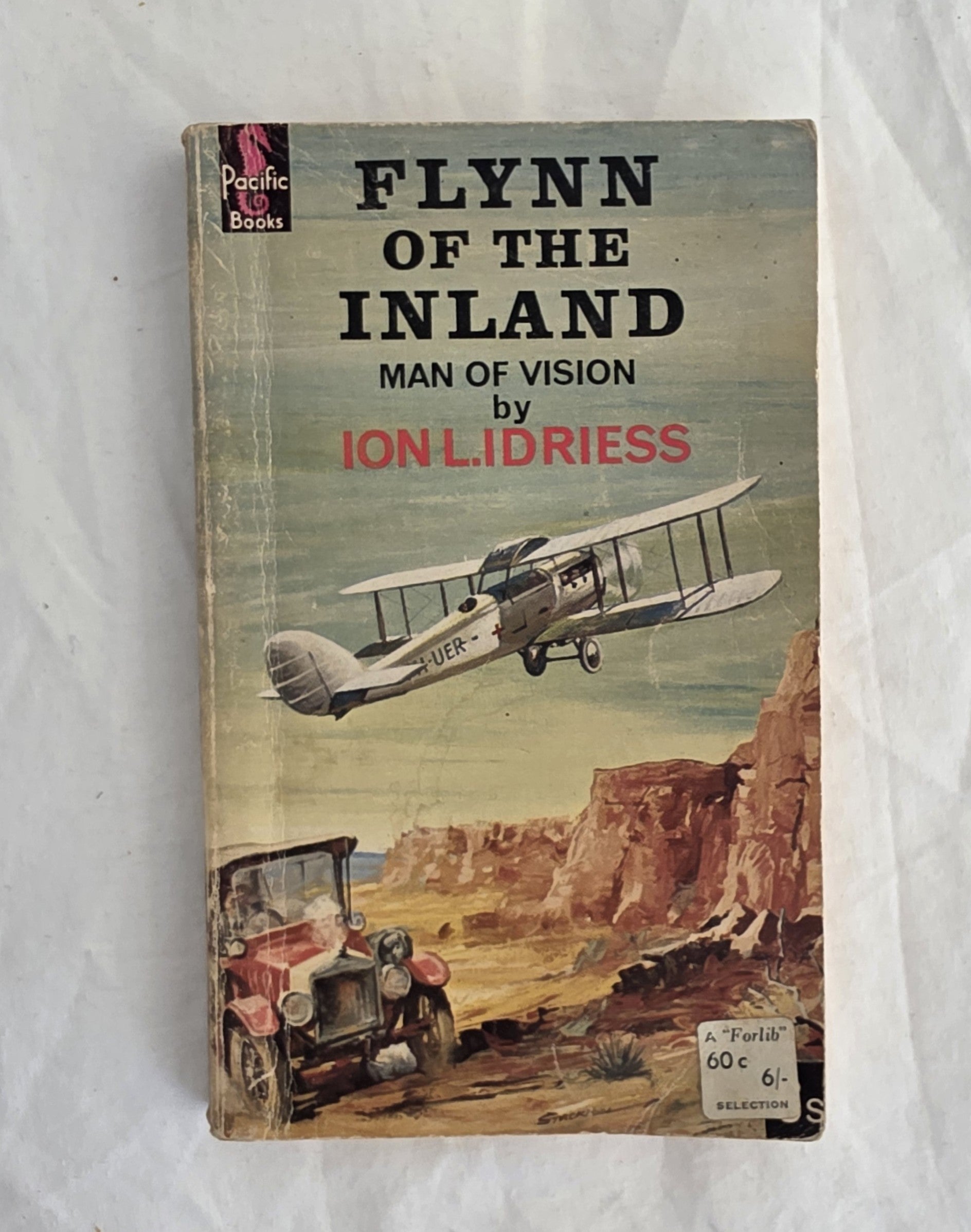 Book cover of 'Flynn of the Inland' by Ion L. Lidriess with an airplane and landscape illustration on a white background.