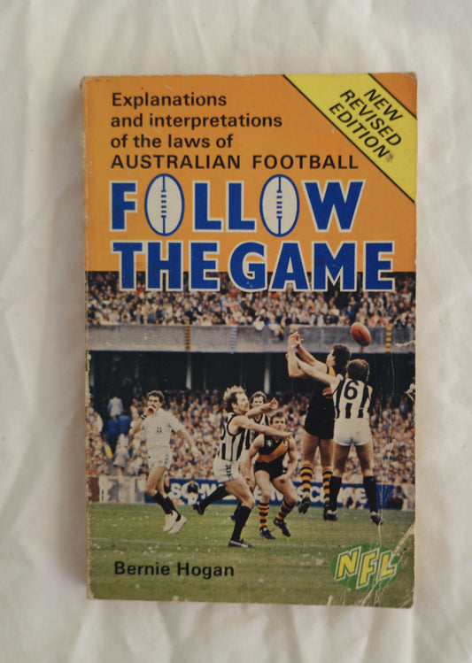 Book titled 'Follow the Game' explaining Australian football laws on a white background