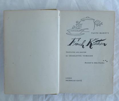 Open book with title page of 'Tante Marie's French Kitchen' on a white background