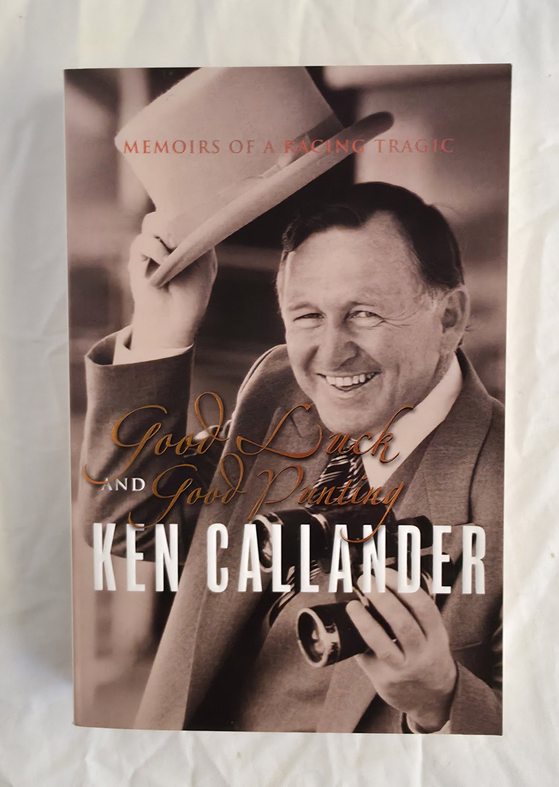 Book cover of 'Good Luck and Gold Mining' by Ken Callander with a sepia-toned photograph of a man holding a hat.