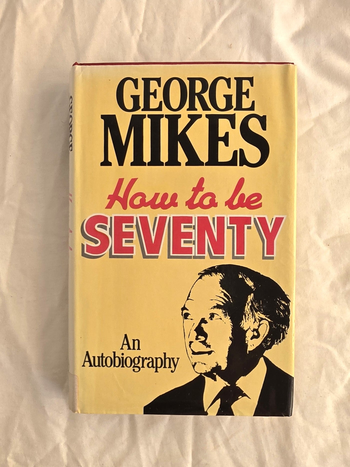 Book cover of 'How to be Seventy' by George Mikes on a textured beige background