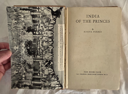 Book titled 'India of the Princes' by Rosita Forbes held open by a hand.