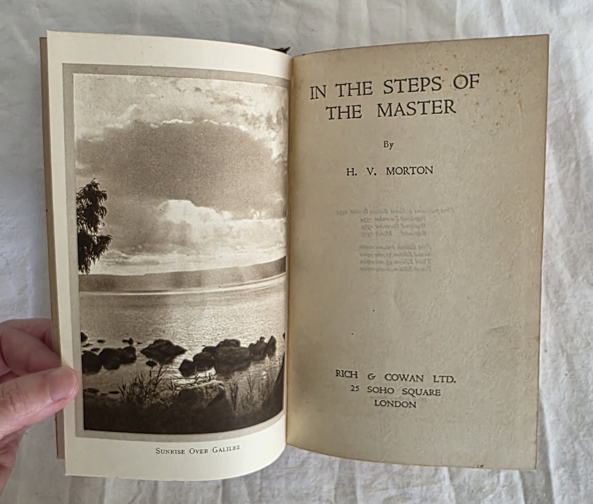 Open book titled 'In the Steps of the Master' by H.V. Morton with a black and white photograph on the left page.
