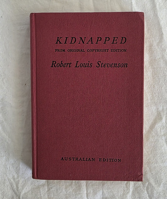 Red book titled 'Kidnapped' by Robert Louis Stevenson on a light background