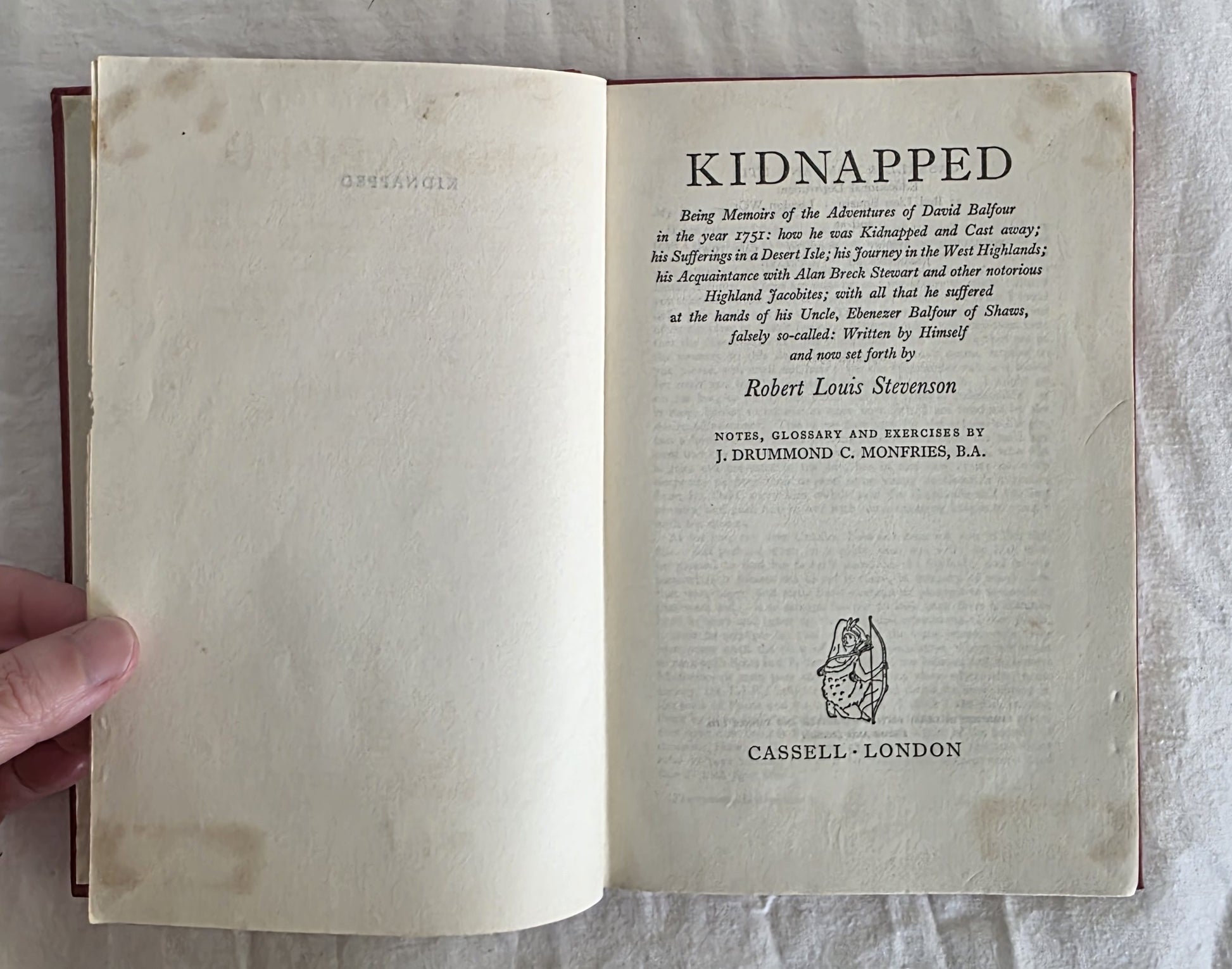 Open book showing the title page of 'Kidnapped' by Robert Louis Stevenson.