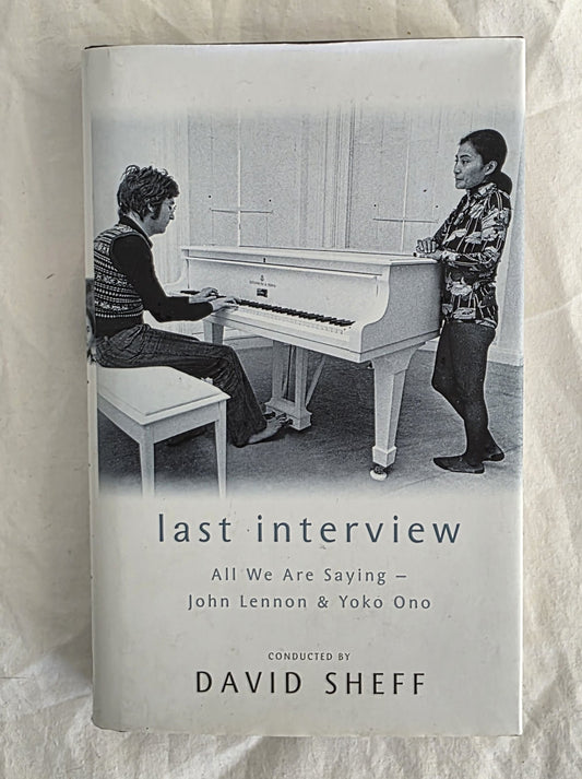 Book cover of 'Last Interview: All We Are Saying - John Lennon & Yoko Ono' with a black and white photo of two people at a piano.
