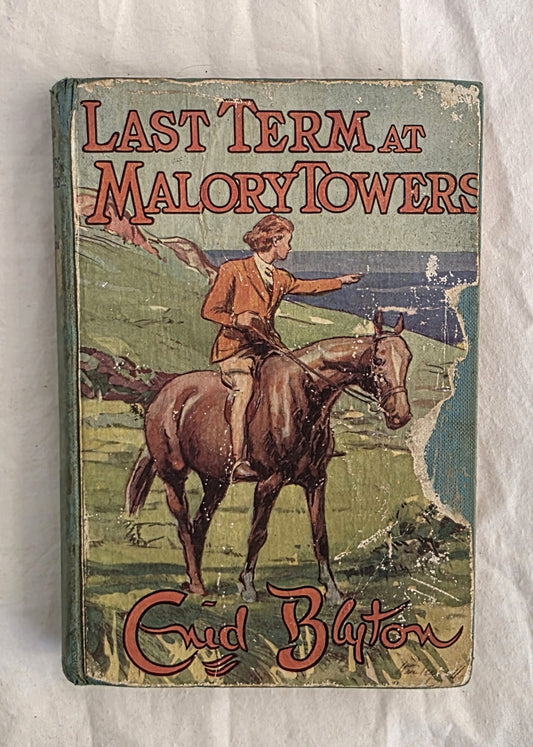 Vintage book cover of 'Last Term at Malory Towers' by Enid Blyton on a textured white background