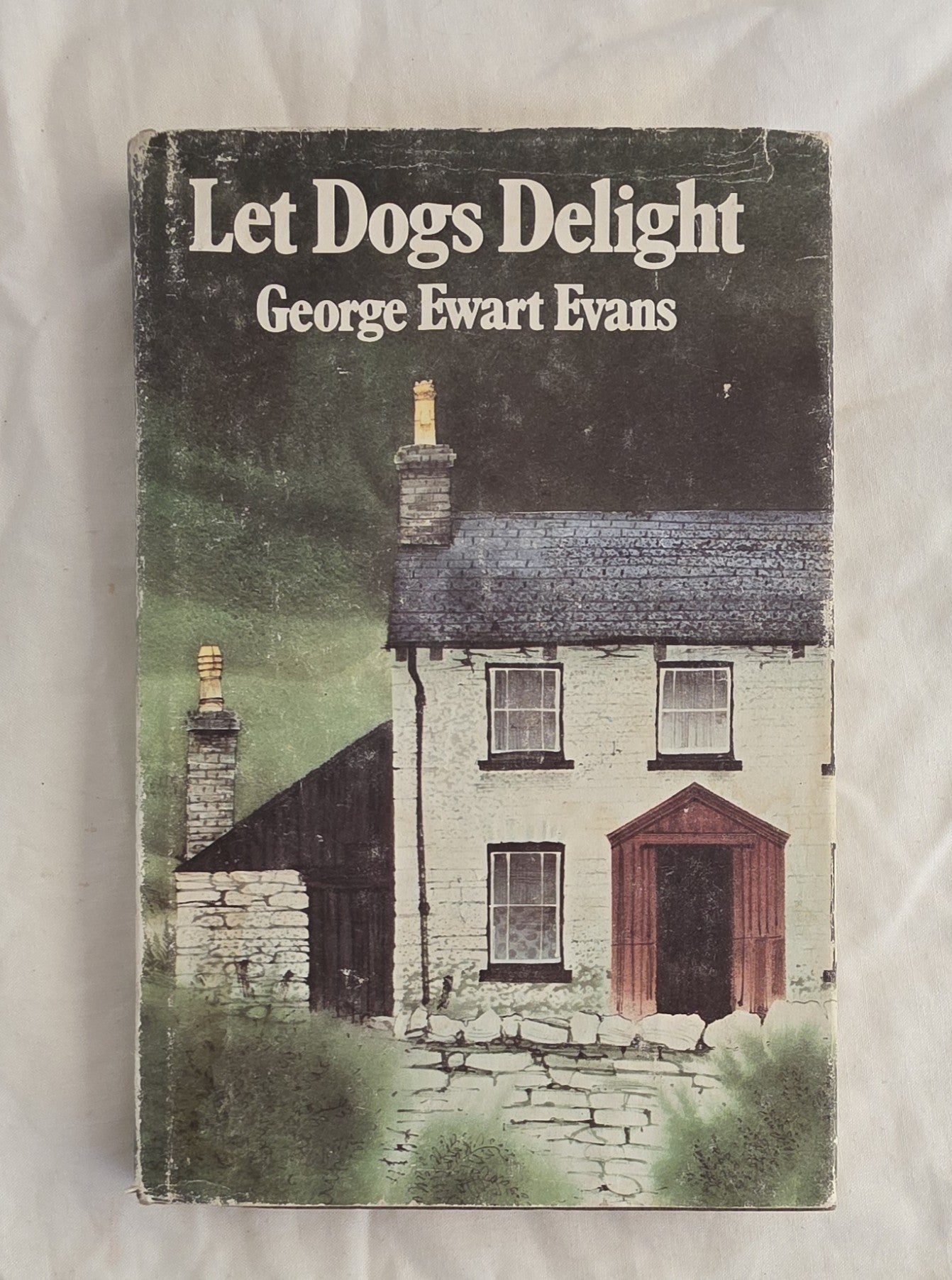 Book cover of 'Let Dogs Delight' by George Ewart Evans with a house illustration on a white background