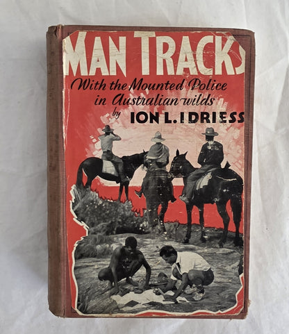 Book cover of 'Man Tracks' with mounted police and Aboriginal people in Australian wilderness, by Ion L. Idriess.