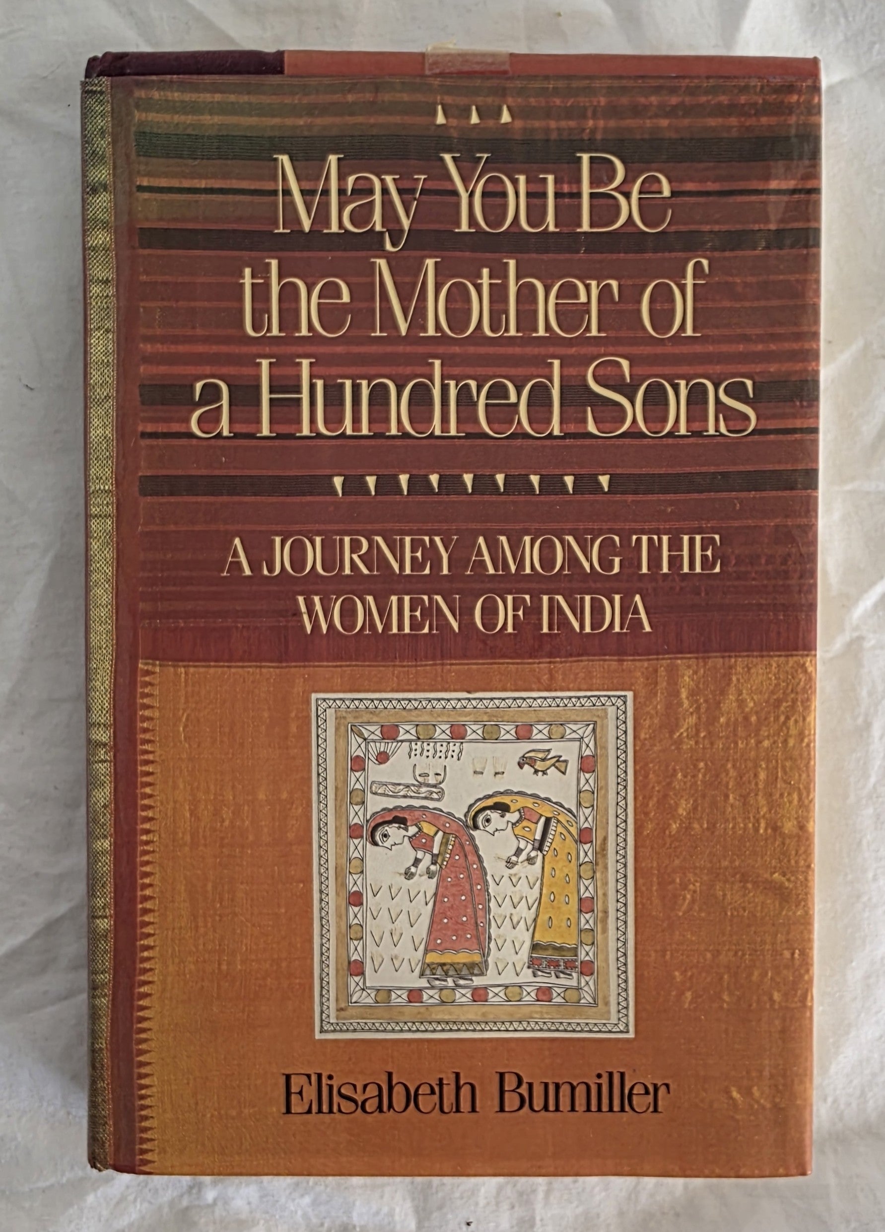 Book titled 'May You Be the Mother of a Hundred Sons' by Elisabeth Bumiller on a textured white background