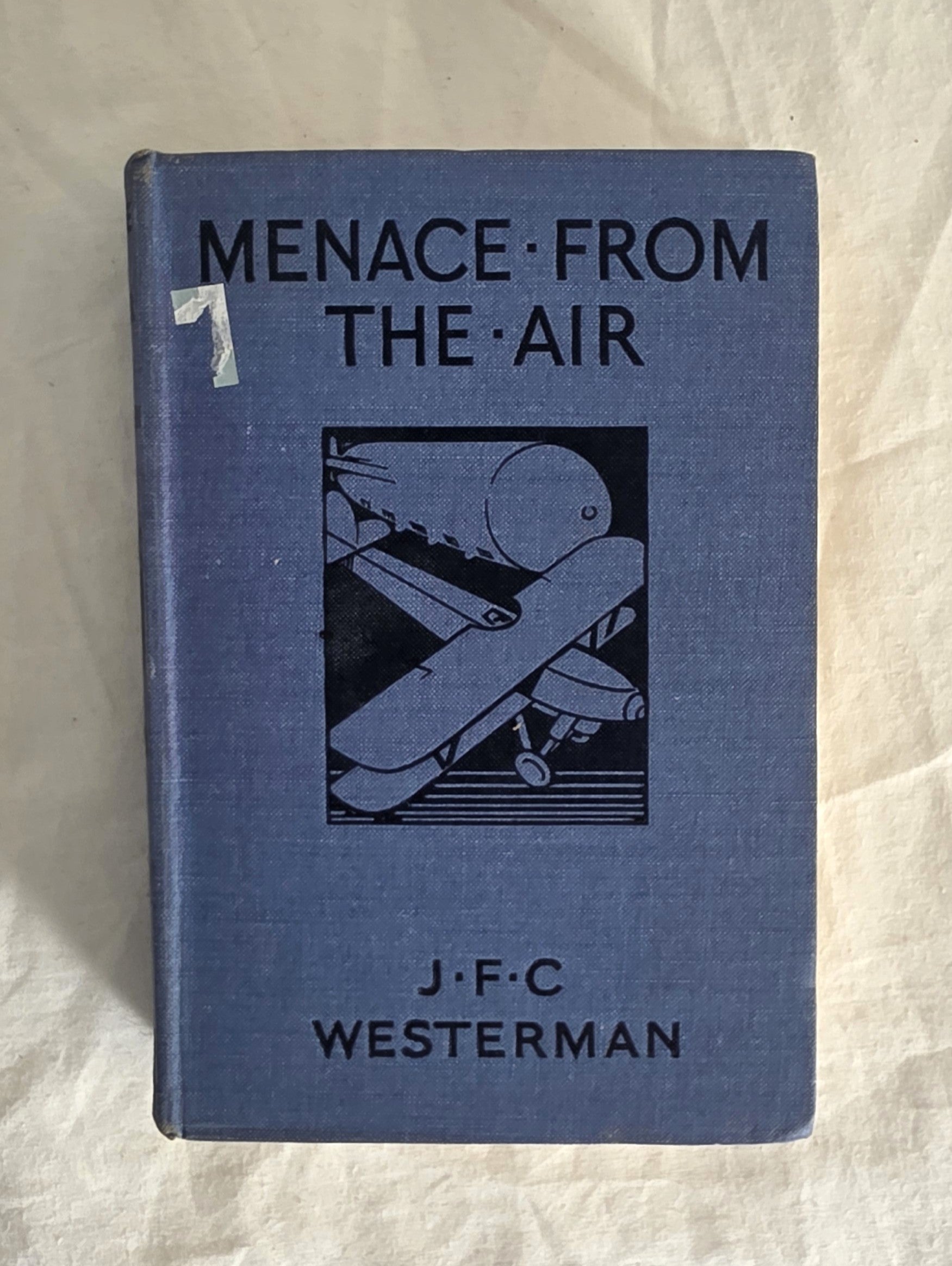 Book titled 'Menace from the Air' by J.F.C. Westerman on a textured beige background