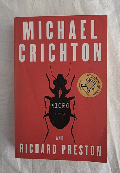 Book cover of 'Micro' by Michael Crichton and Richard Preston on a textured surface