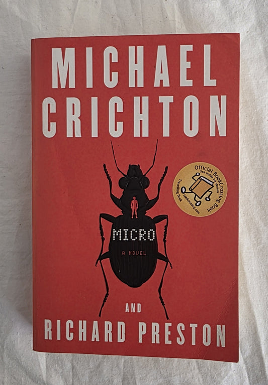 Book cover of 'Micro' by Michael Crichton and Richard Preston on a textured surface