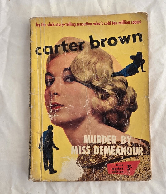 Vintage book cover with a woman's face and text about Carter Brown's 'Murder by Miss Demeanor' on a white background.