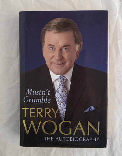 Book cover of 'Mustn't Grumble' by Terry Wogan on a textured white background
