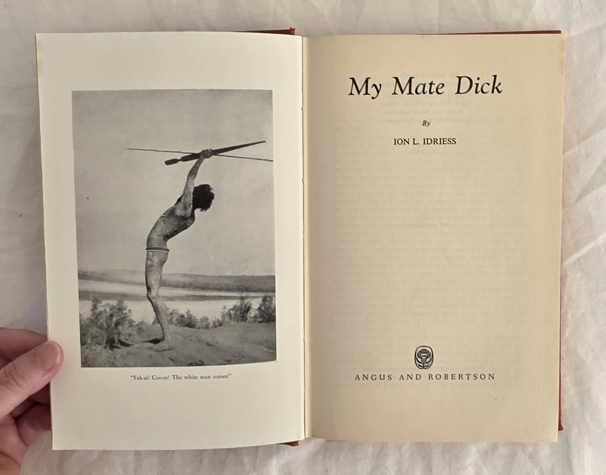 Open book titled 'My Mate Dick' by Jon L. Idriess, held against a white background.
