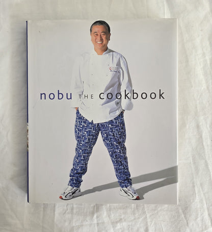 Cookbook titled 'nobu THE COOKBOOK' with a person wearing a chef's outfit on the cover.