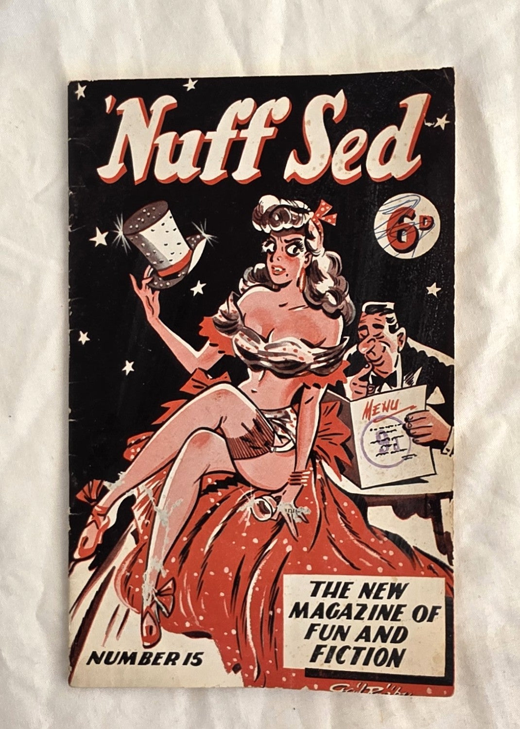 Vintage comic book cover titled 'Nuff Sed' with a woman in a red dress and a man in a top hat on a white background.