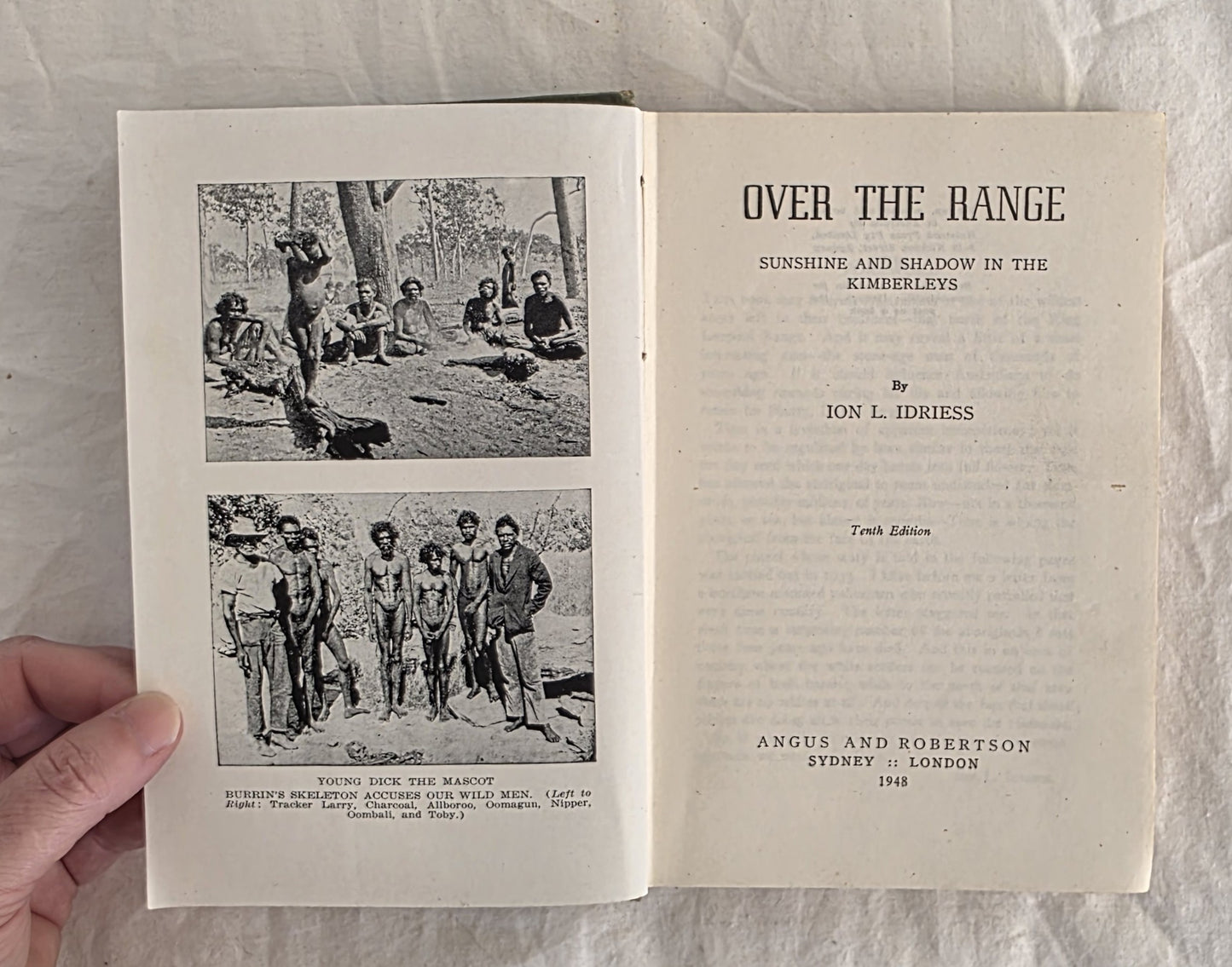 Open book titled 'Over the Range' with black and white illustrations on a textured surface.