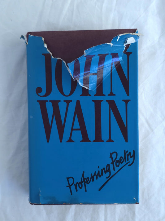Blue book with 'John Wain Professing Poetry' on a white background