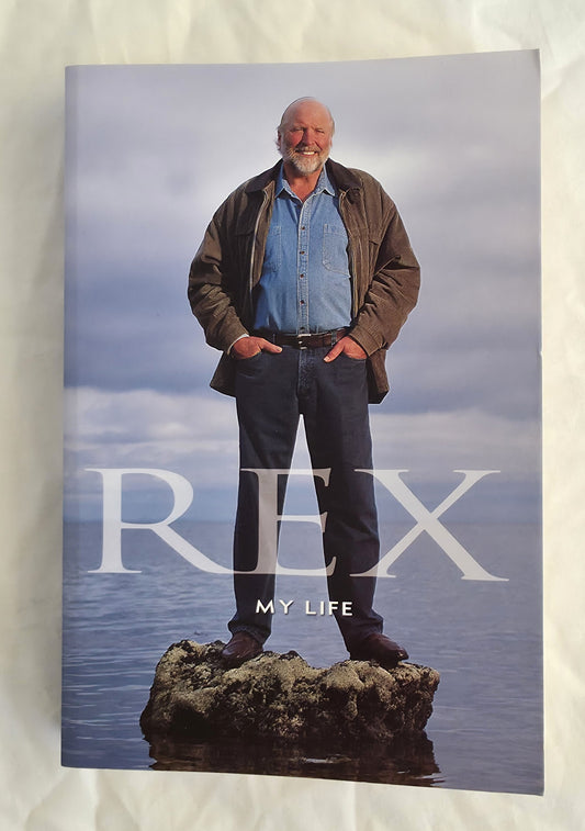 Book cover titled 'Rex My Life' featuring a person standing on a rock with water in the background.