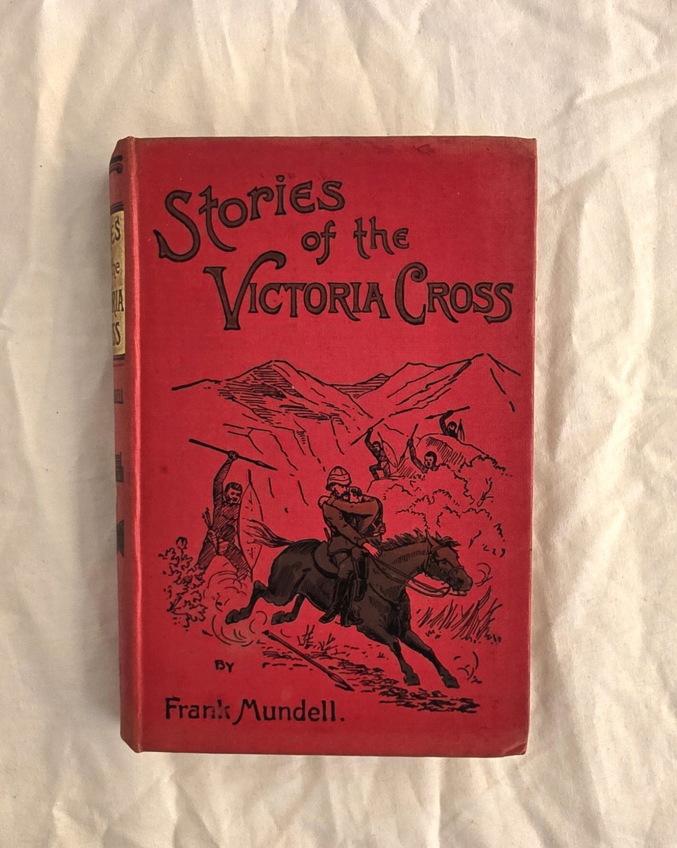 Red book titled 'Stories of the Victoria Cross' by Frank Mundell on a white background