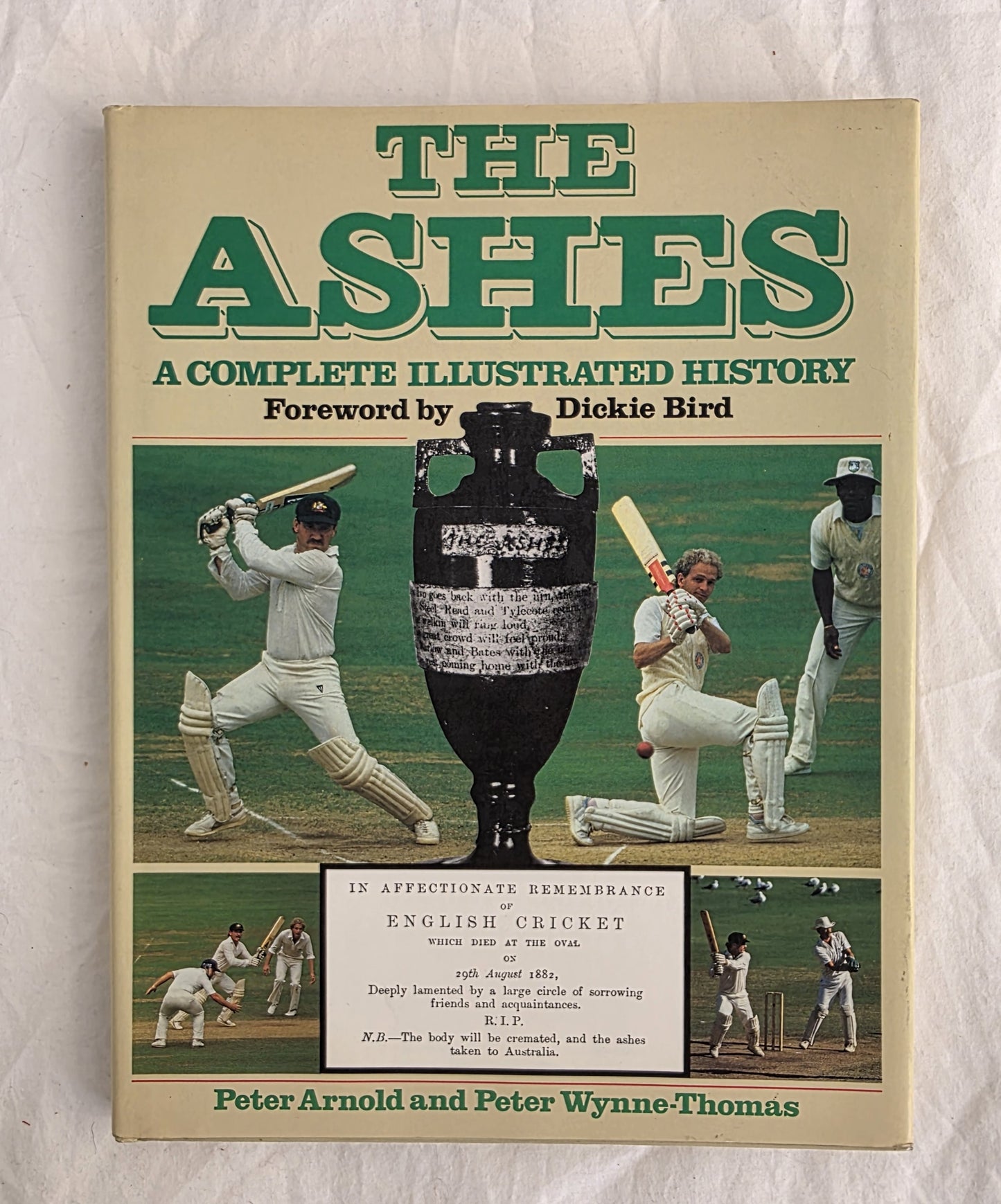 Book cover of 'The Ashes: A Complete Illustrated History' with cricket imagery and trophy.