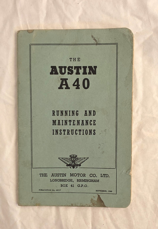 Booklet titled 'The Austin A40 Running and Maintenance Instructions' on a textured surface