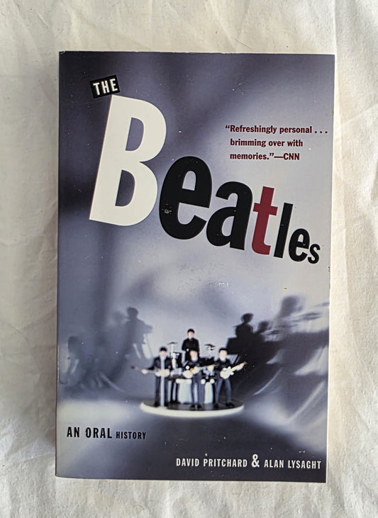 Book cover of 'The Beatles: An Oral History' on a textured surface