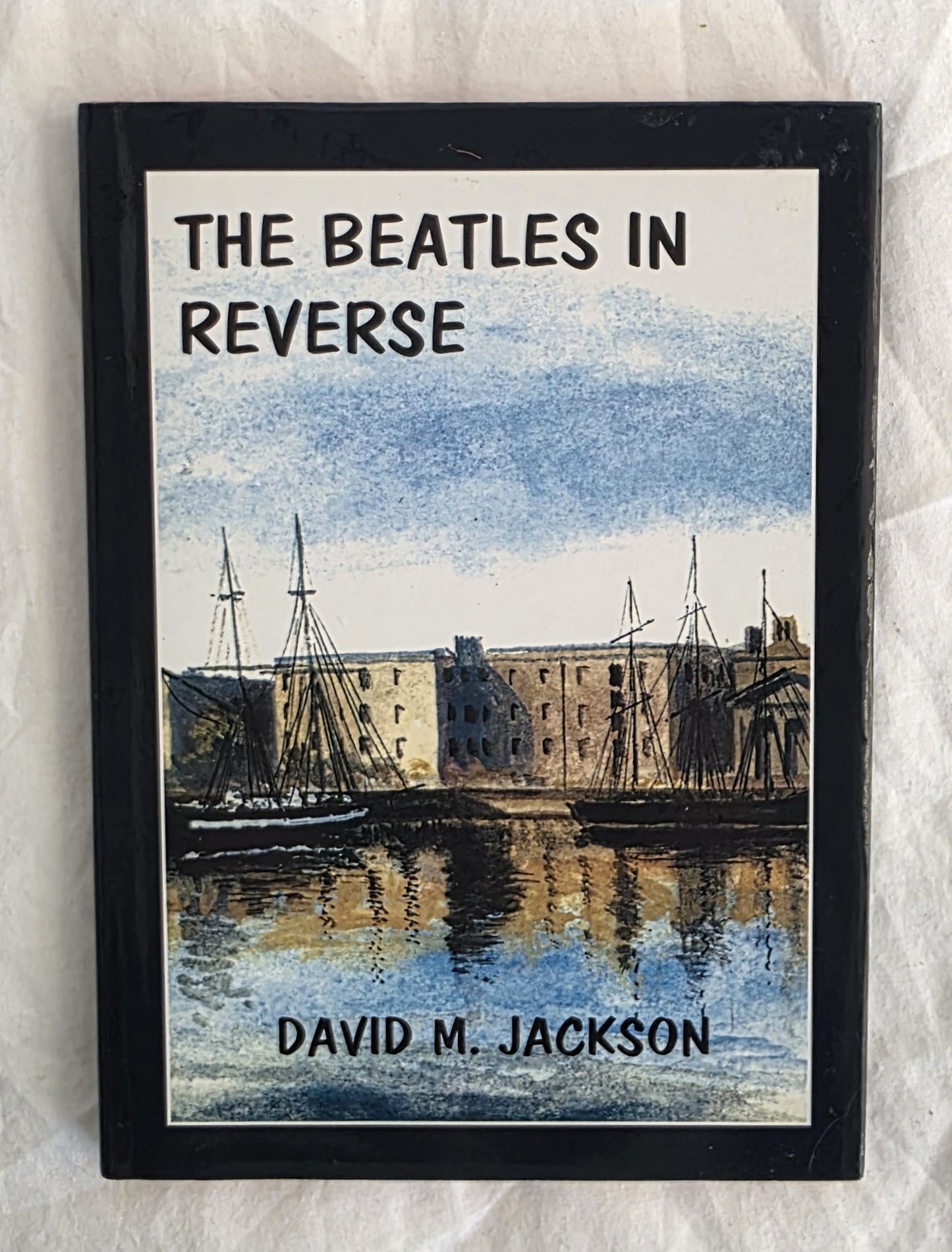 Book titled 'The Beatles in Reverse' by David M. Jackson on a textured white background