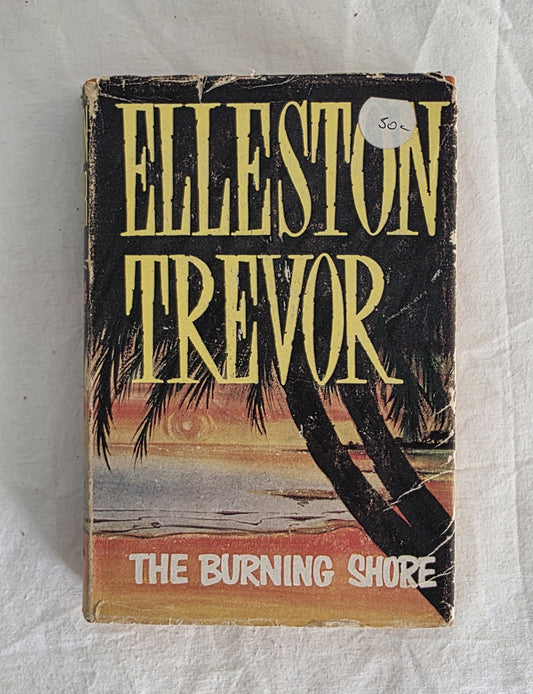 Book cover of 'The Burning Shore' by Elleston Trevor on a textured surface