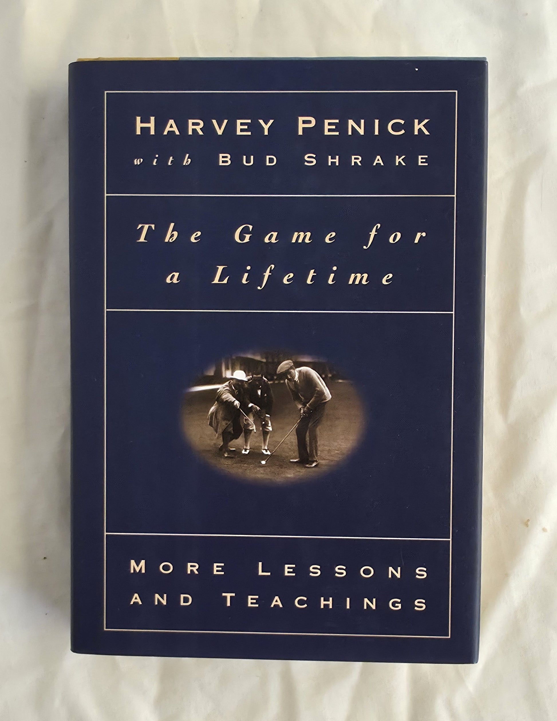 Book titled 'The Game for a Lifetime' by Harvey Penick with Bud Shrake on a white background